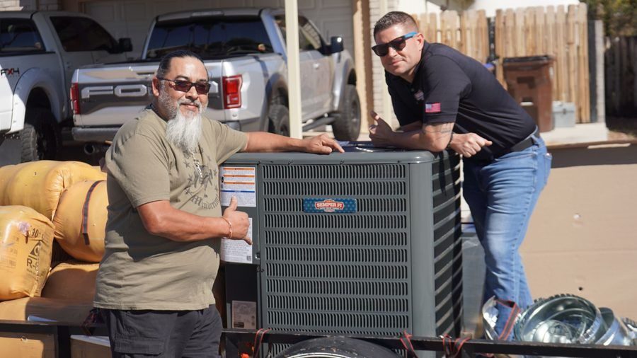 Two Semper Fi techs posing with an AC unit.