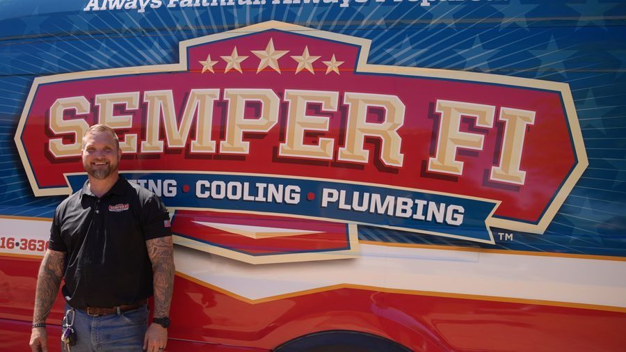 Semper tech standing in front of van.