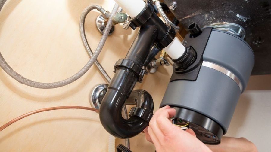 Garbage disposal installed under sink.