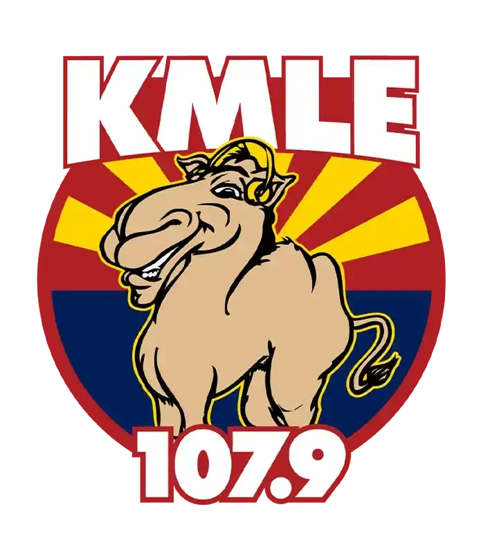 KMLE 107.9 radio logo with a cartoon camel in front of a sunburst shield on a red background.
