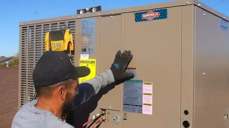 Technician servicing a commercial rooftop HVAC unit to maintain reliable heating and cooling for a commercial building.