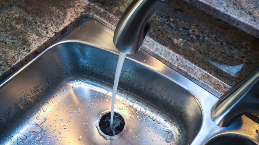 Faucet on with water in the sink.