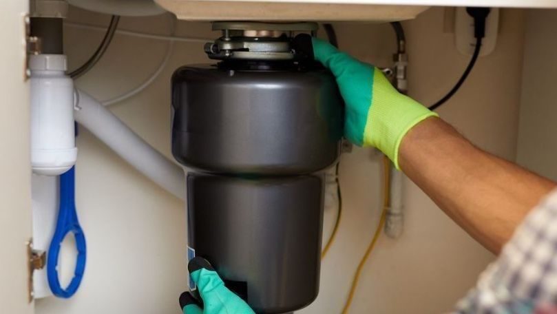 Garbage disposal being installed.