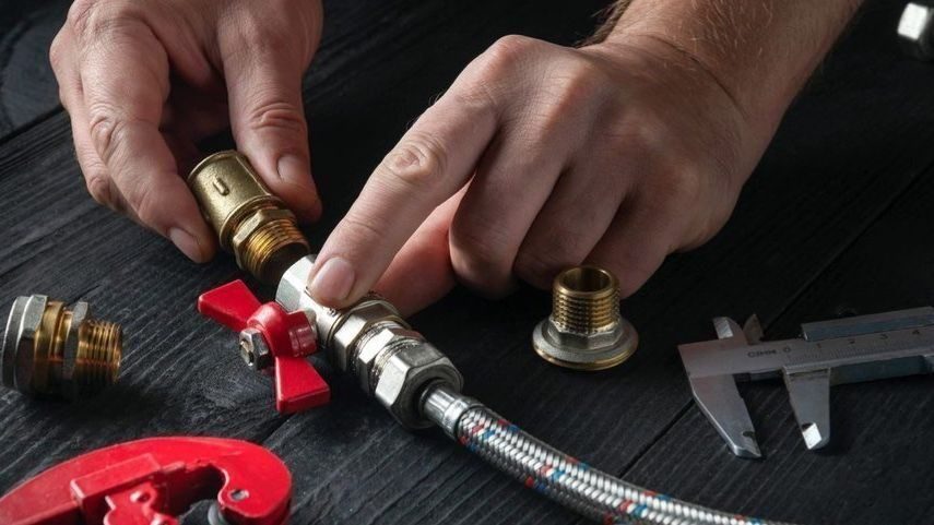 Technician holding gas lines.