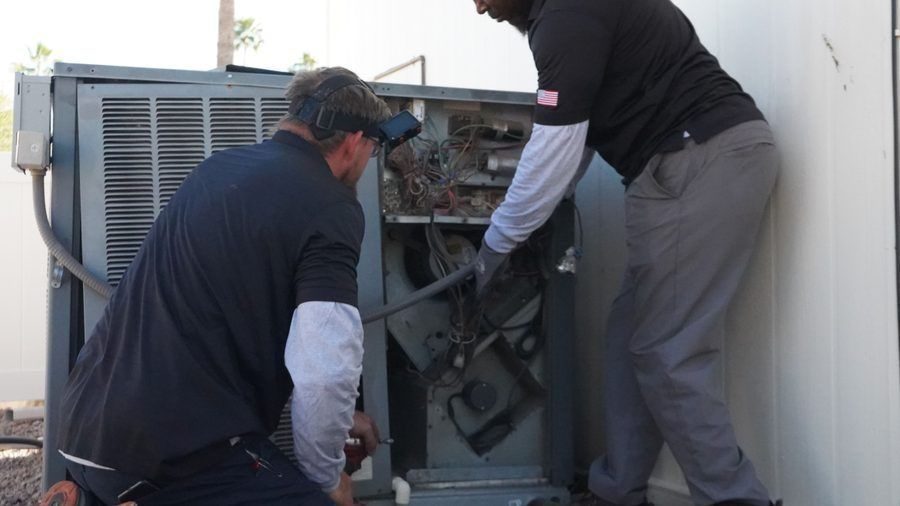 Two techs repairing a heater.