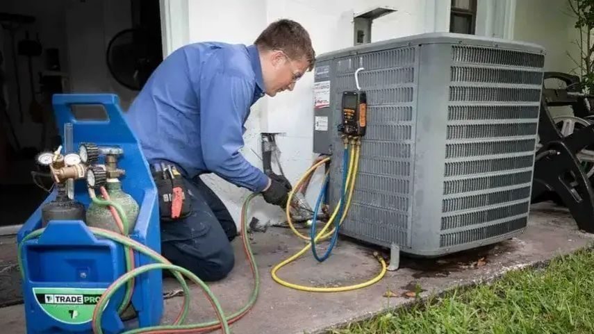 HVAC tech repairing air conditioning unit.