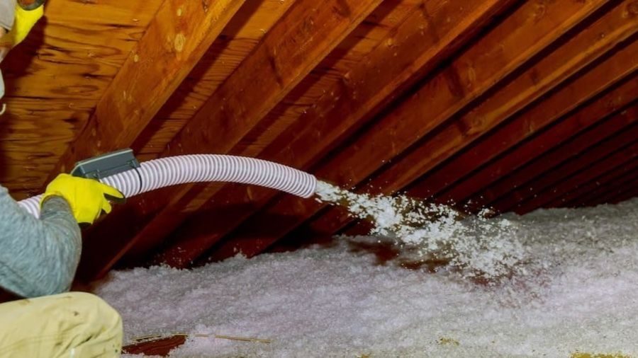 Attic insulation being put into attic.