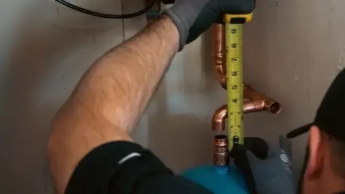 Semper Fi plumber measuring pipe.