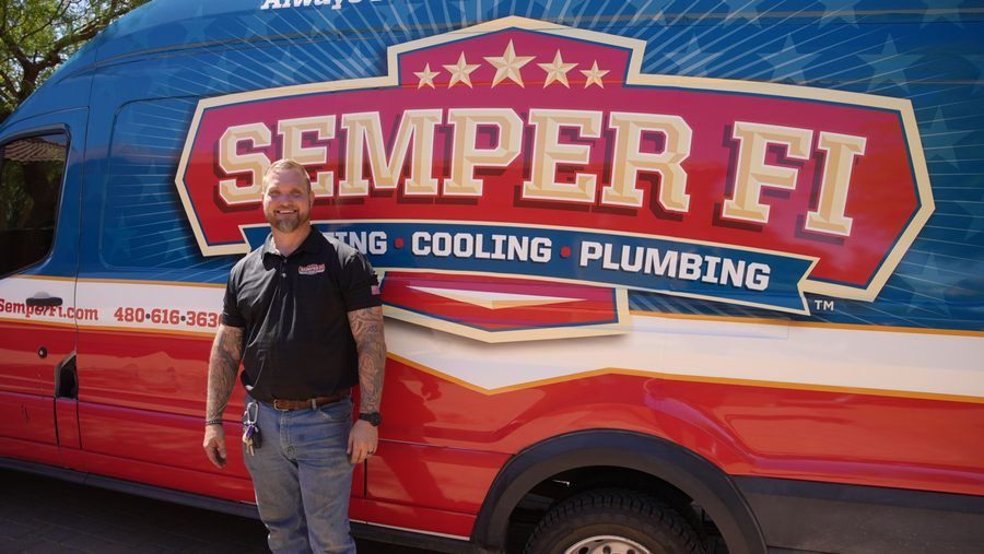 HVAC tech standing in front of Semper Fi