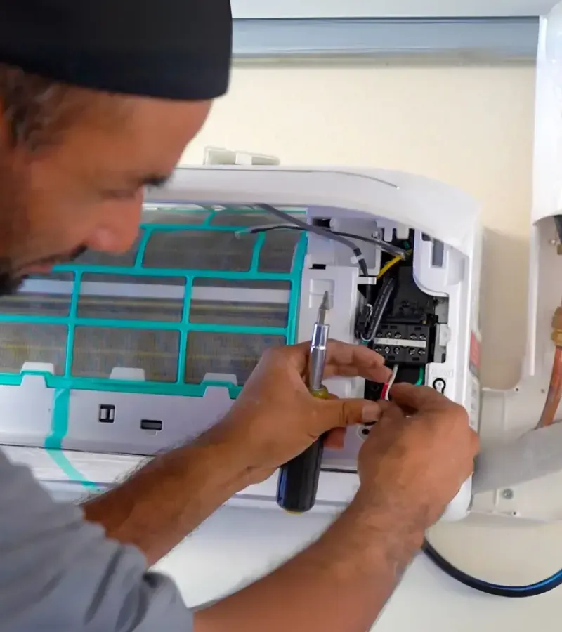 Technician repairing air conditioner