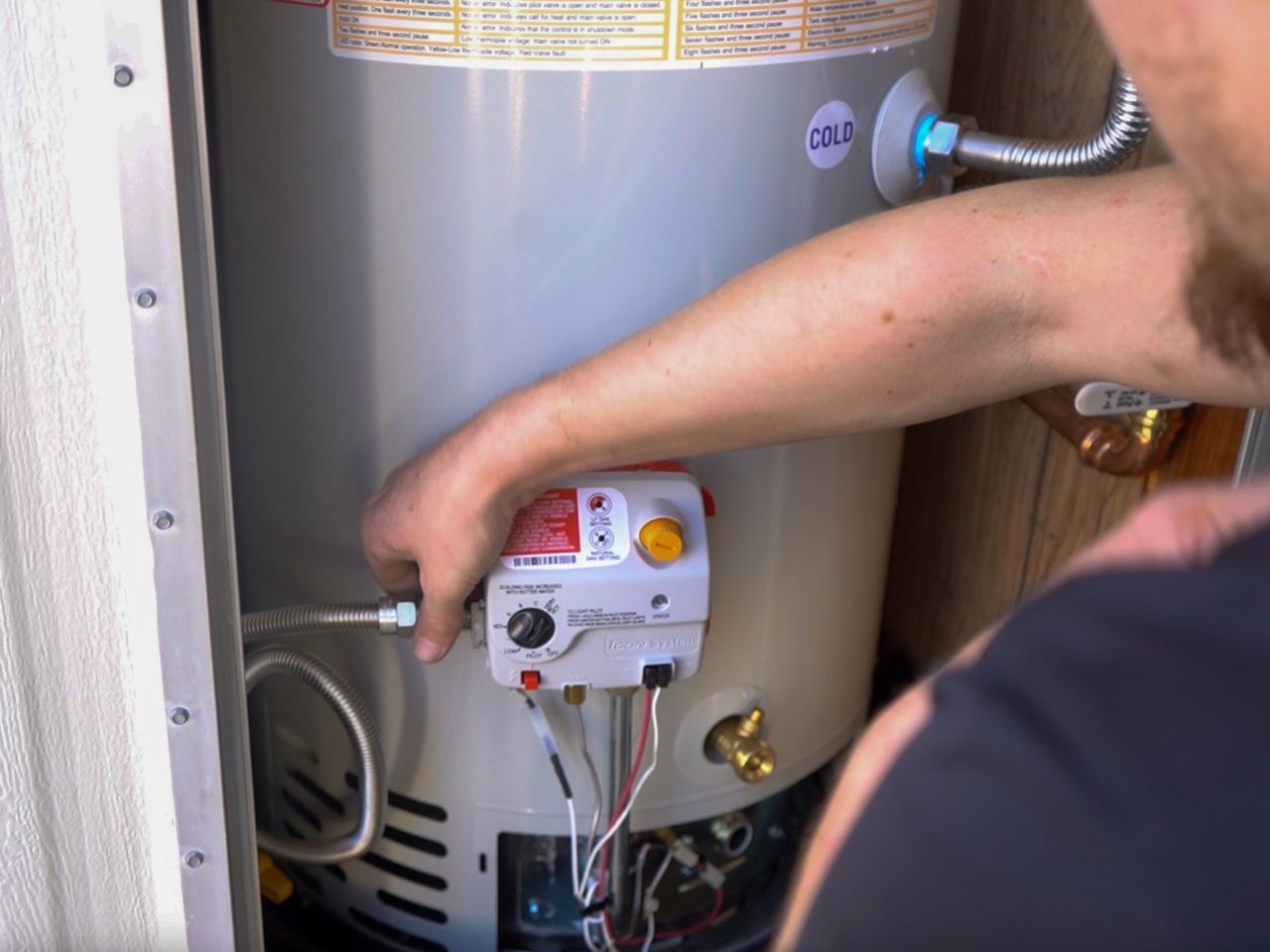 Plumber repairing water heater