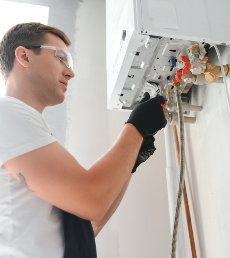 Plumber fixing water heater 