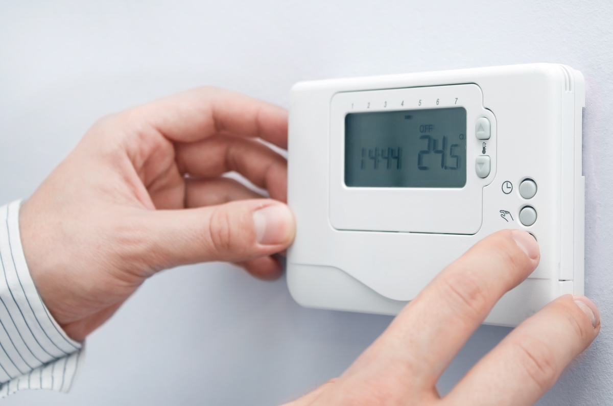 Mesa, AZ Homeowner adjusts thermostat to save money on heating bills during winter