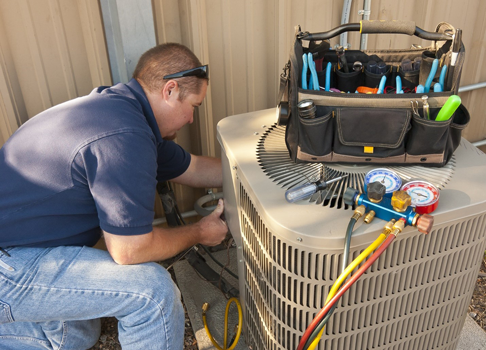 hvac professional fixing AC unit